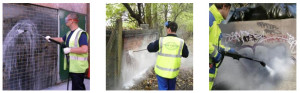 men power washing a wall