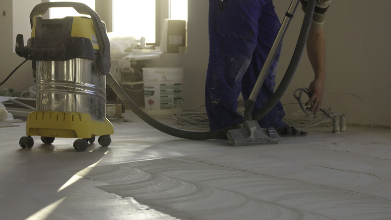 a worker cleaning up after a builder