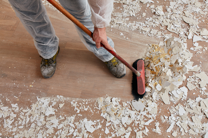 after builders cleaning service sweeping up plaster and paint chips